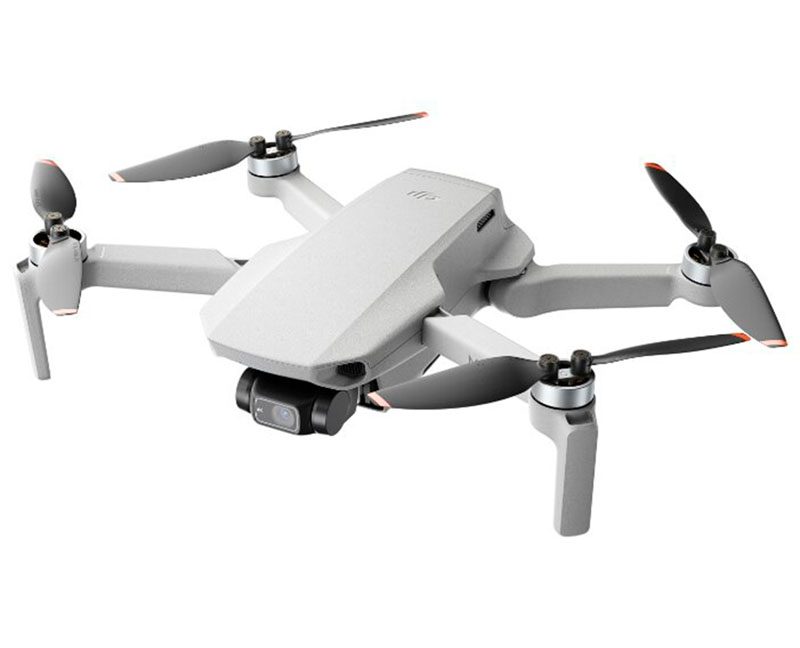 Компактный квадрокоптер DJI Mini 2 серого цвета в разложенном виде на белом фоне